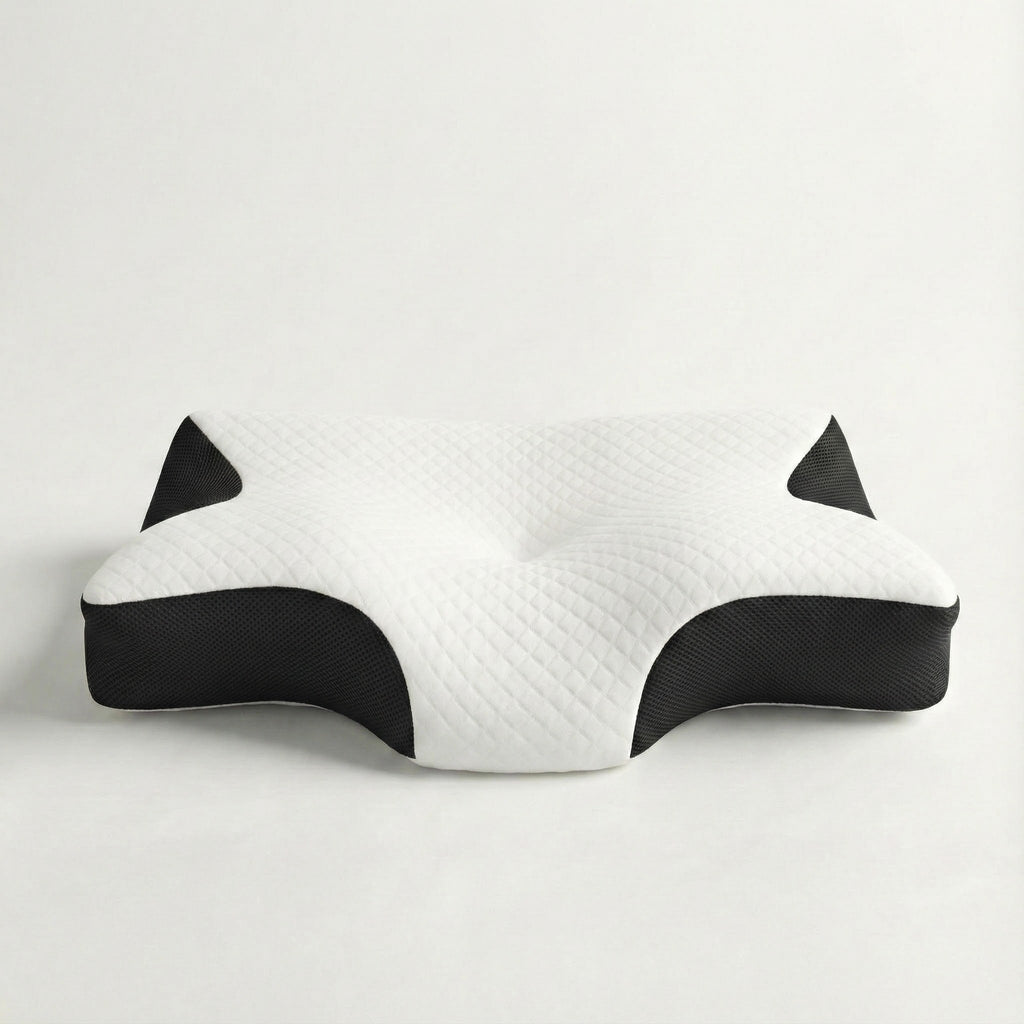 White and black cat-shaped pillow on a light gray background