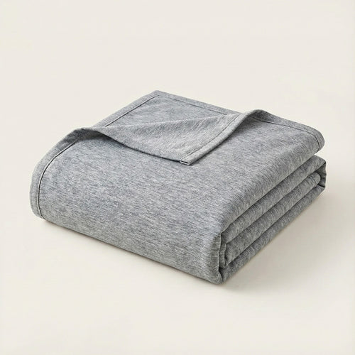 Folded gray blanket on a light beige background