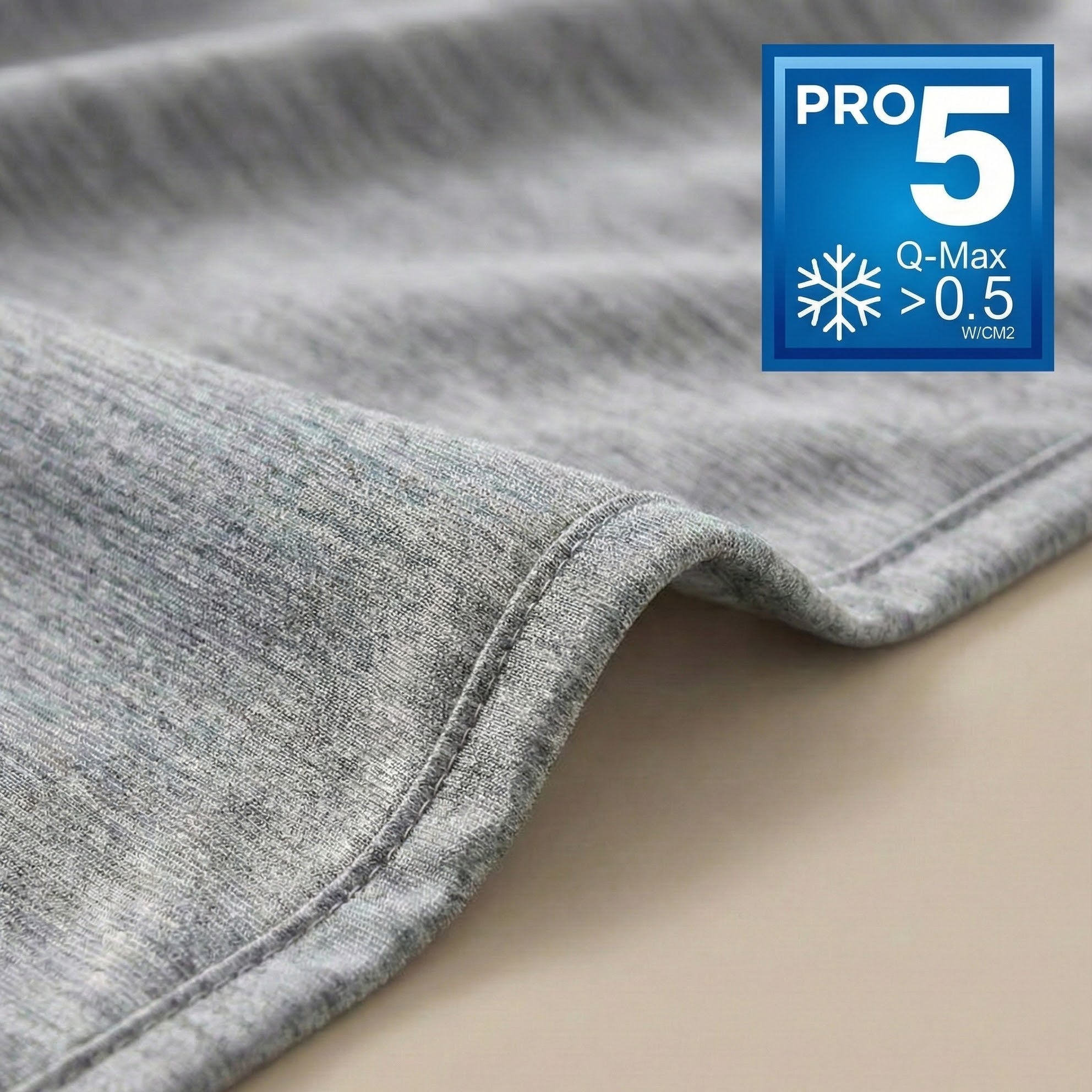 Gray fabric with a Pro 5 Q-Max >0.5 W/m2k label on a beige background