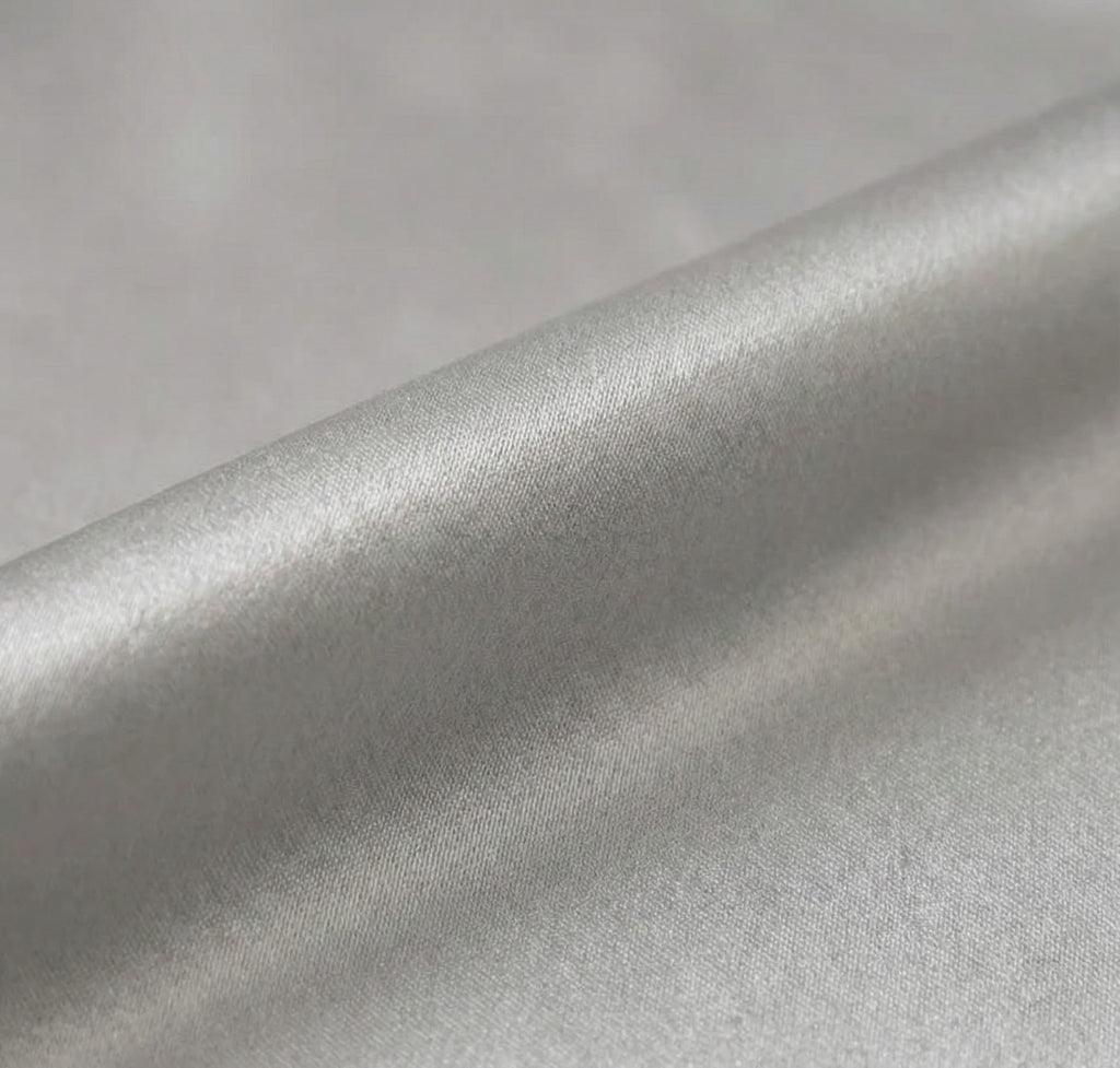 Close-up of silver metallic fabric with a soft texture.