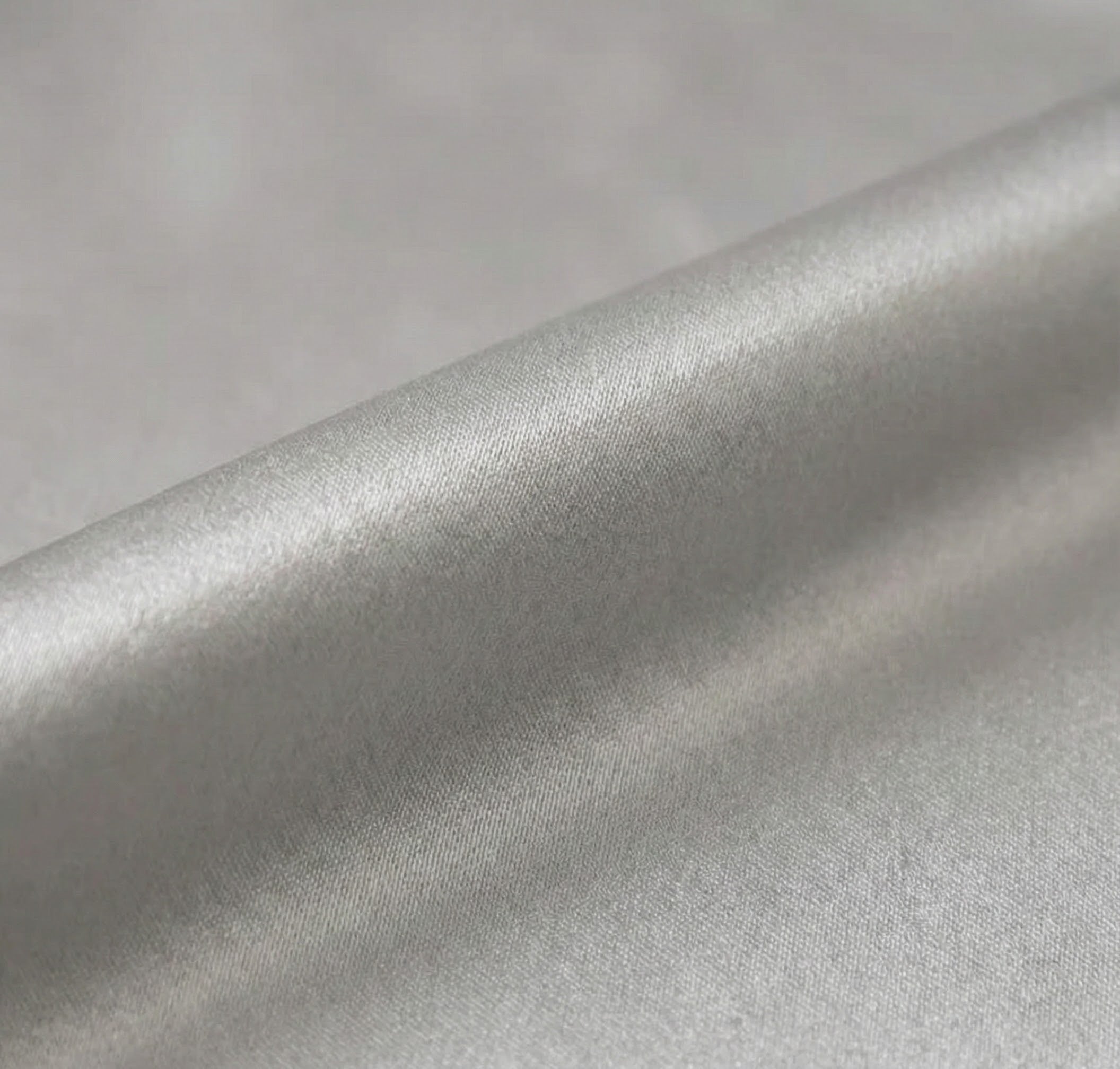 Close-up of silver metallic fabric with a soft texture.