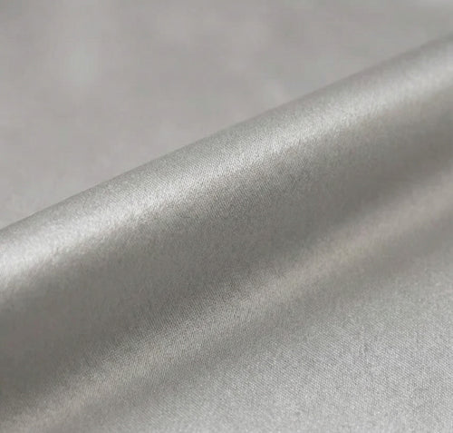 Close-up of silver metallic fabric with a soft texture.