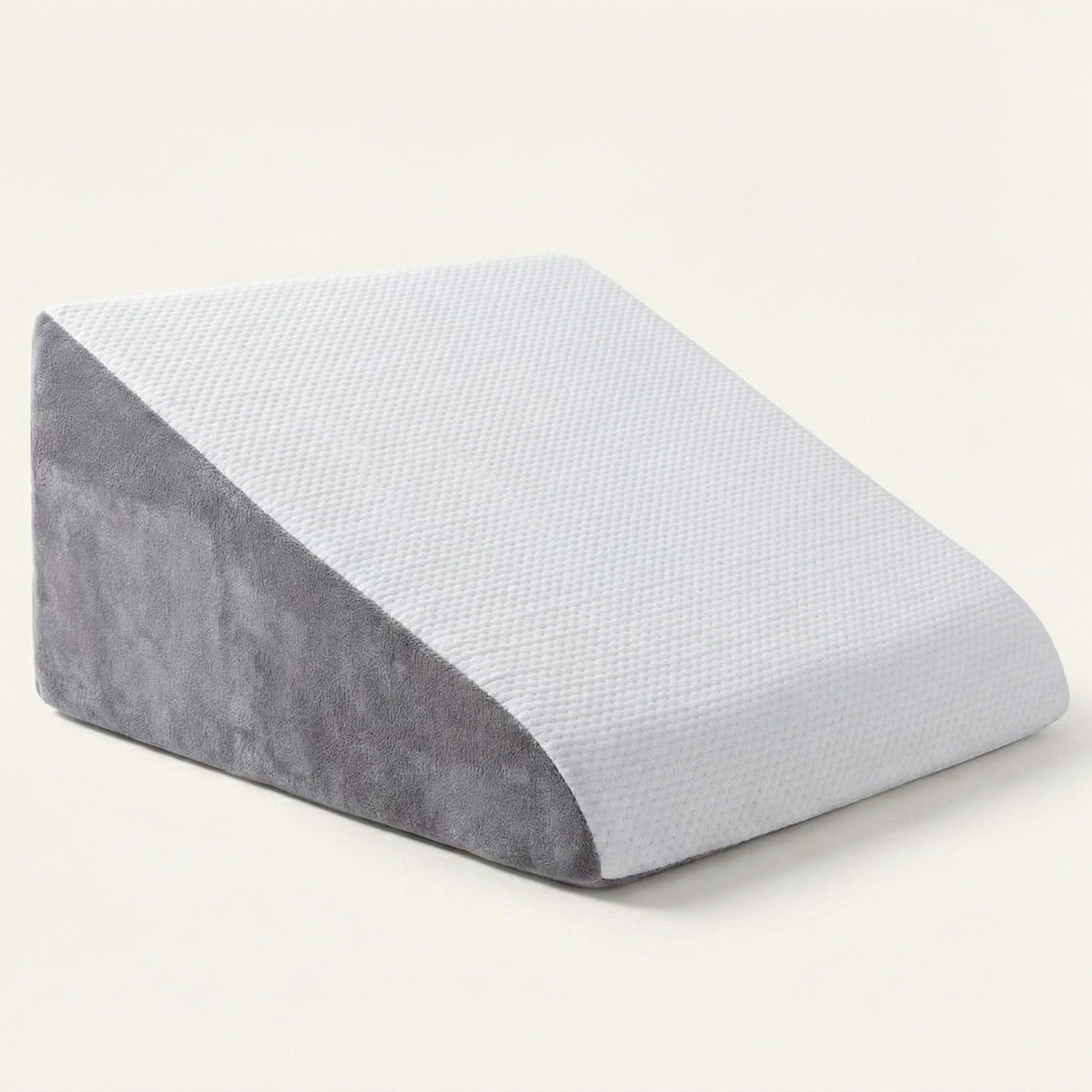 Gray and white wedge pillow on a light beige background