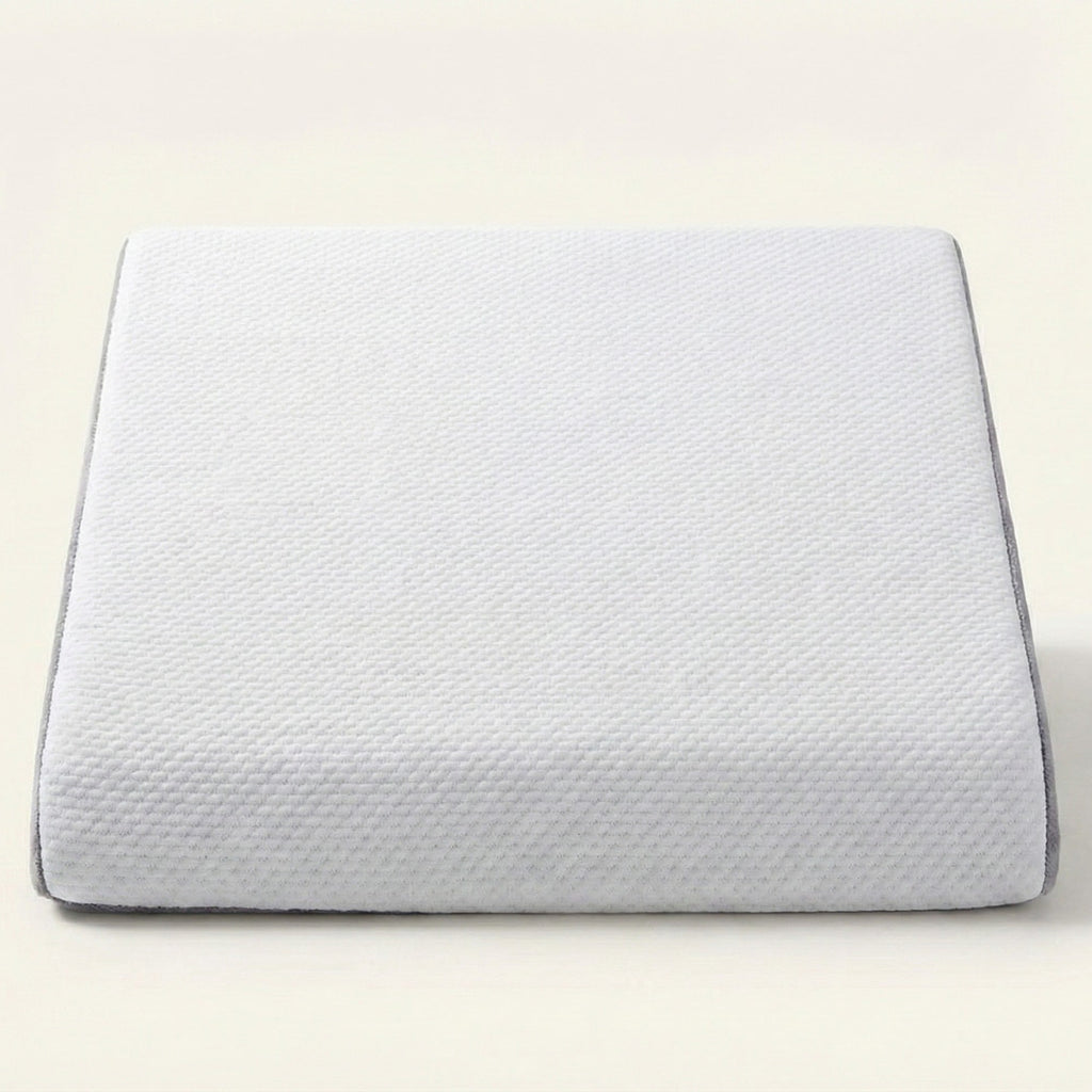 White pillow with textured surface on a light beige background