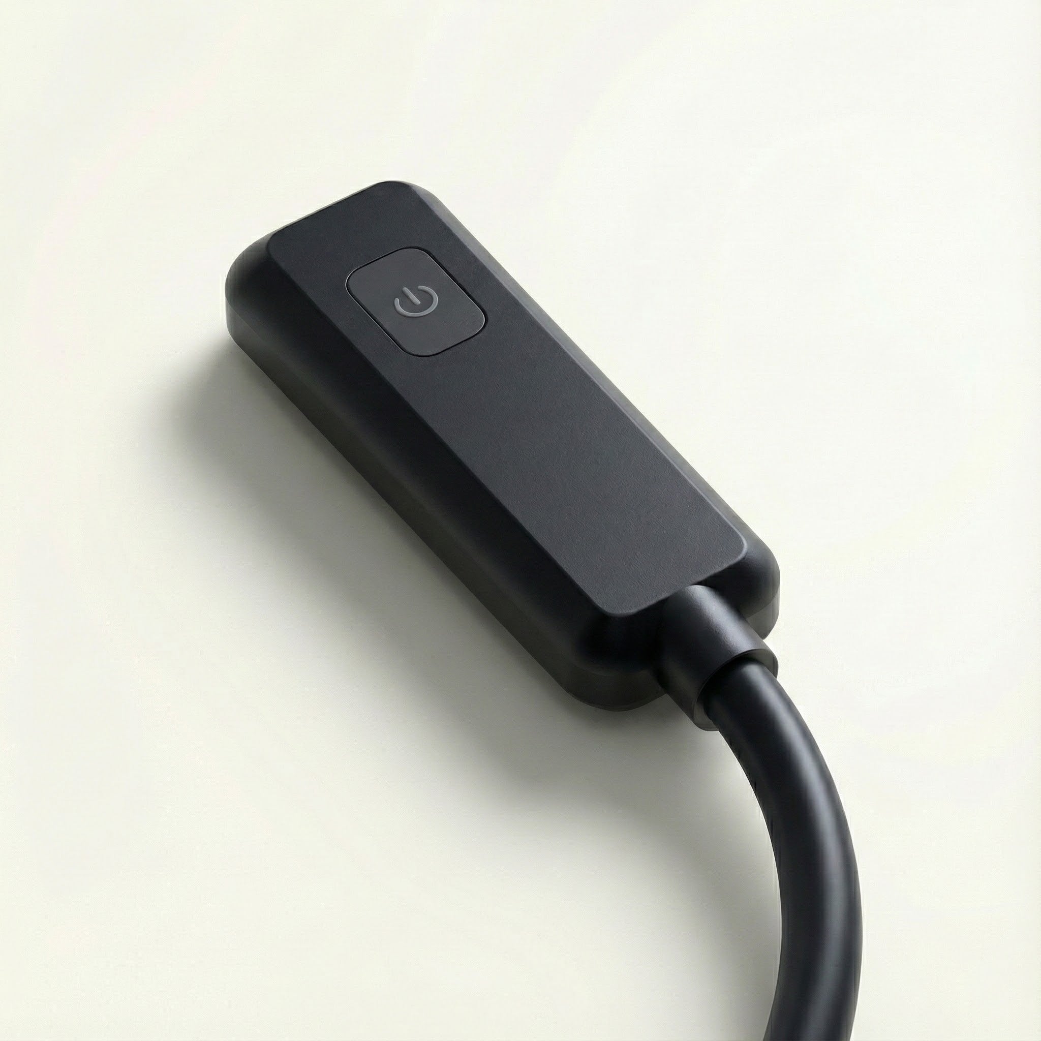 Black electronic device with power symbol on a light background