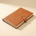 Brown leather notebook on a beige background