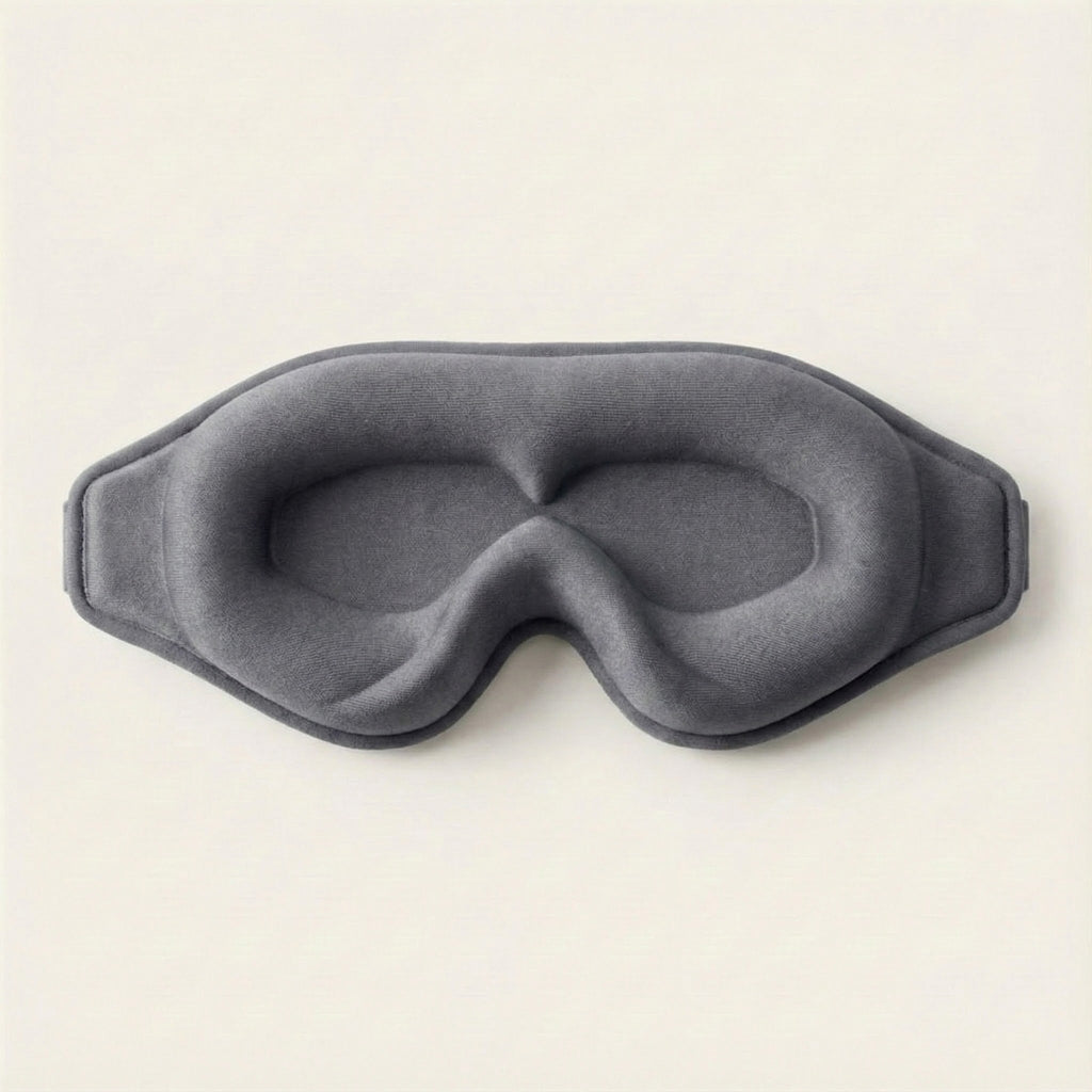 Gray eye mask on a light beige background