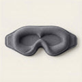 Gray eye mask on a light beige background