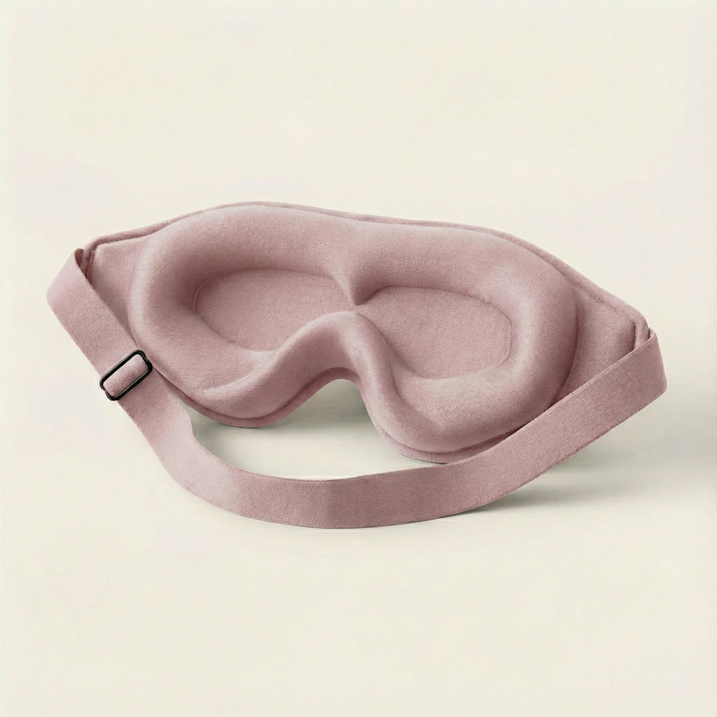 Pink sleep mask on a beige background