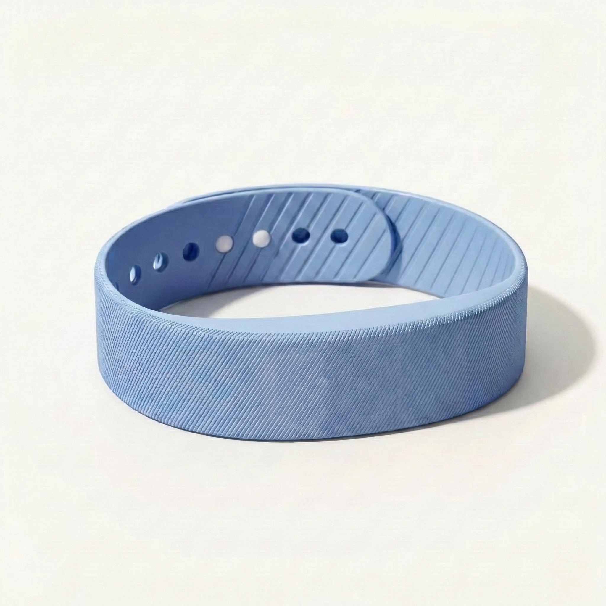 Blue fitness tracker band on a light beige background