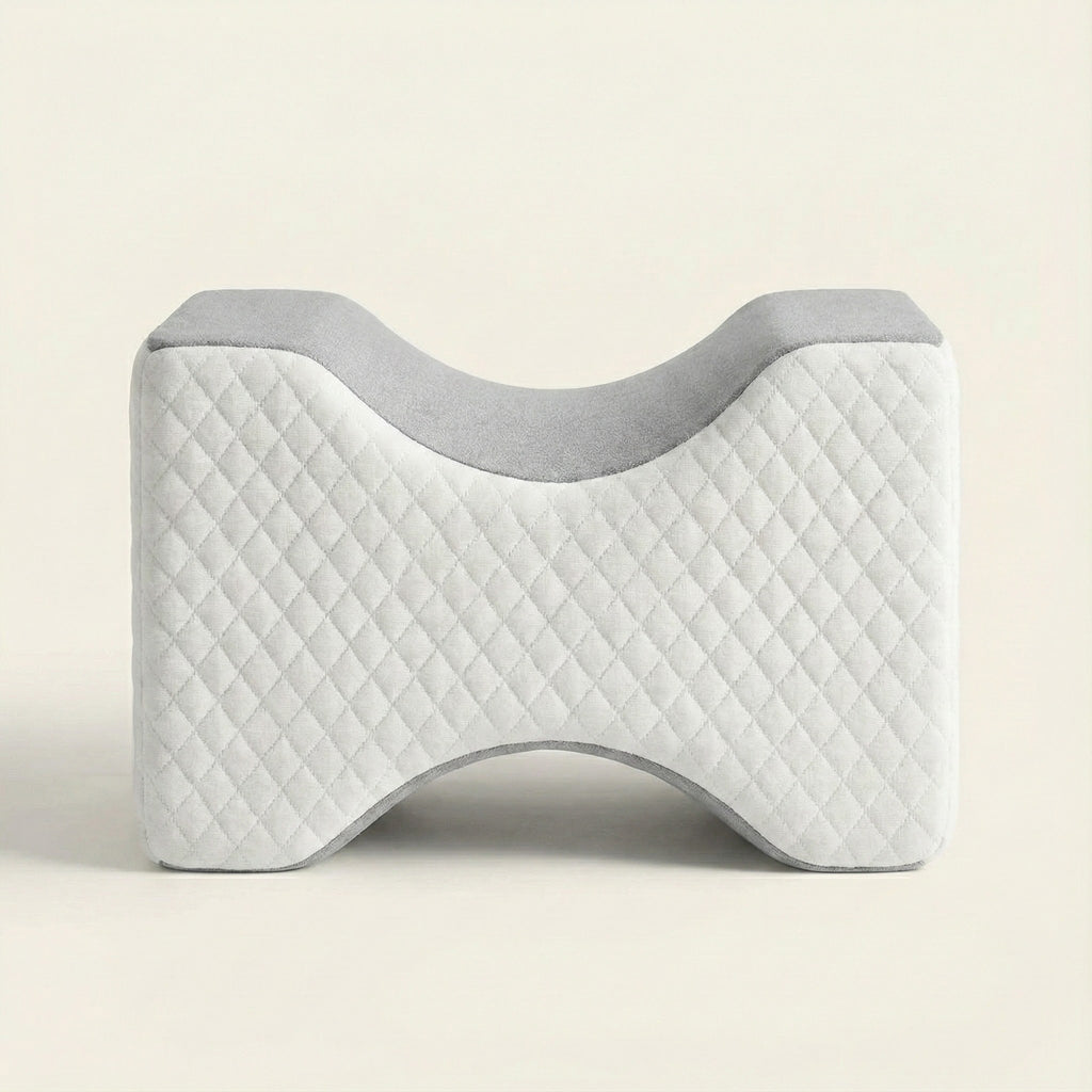 Gray and white quilted pillow on a beige background