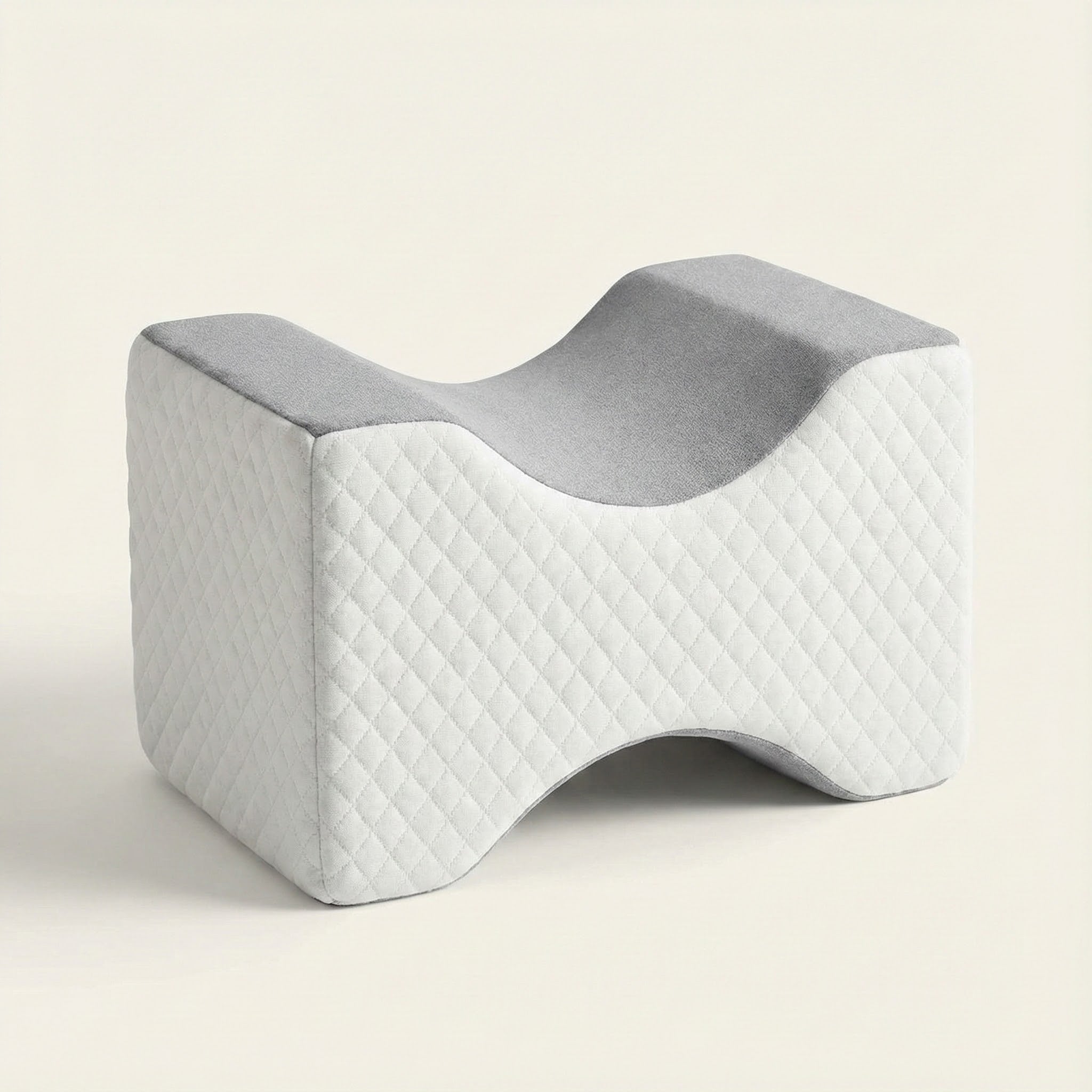 Gray and white wedge-shaped pillow on a beige background